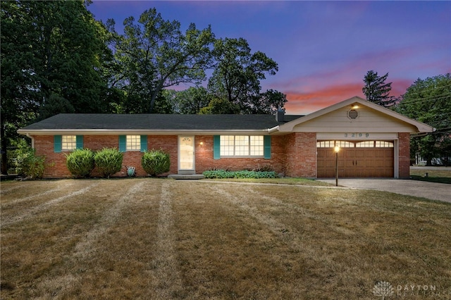 ranch-style house with brick siding, driveway, a front lawn, and a garage