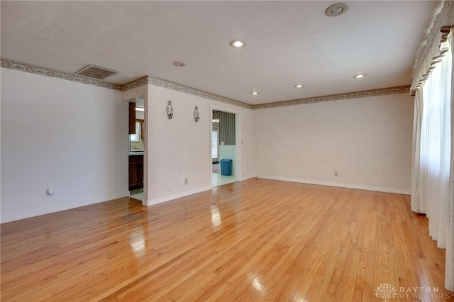 spare room featuring visible vents, recessed lighting, light wood-type flooring, and baseboards