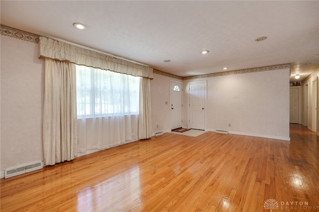 spare room with recessed lighting, visible vents, wood-type flooring, and baseboards