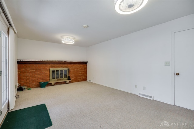 unfurnished living room with visible vents, a fireplace, and carpet flooring