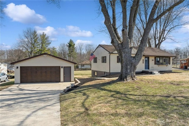 view of front facade with an outbuilding, a detached garage, and a front lawn