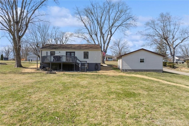 rear view of house with a yard, a deck, and stairs