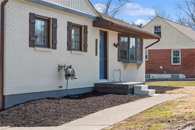 view of front facade with brick siding and board and batten siding