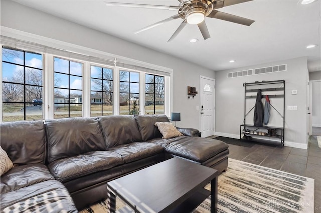 living area with baseboards, recessed lighting, visible vents, and ceiling fan