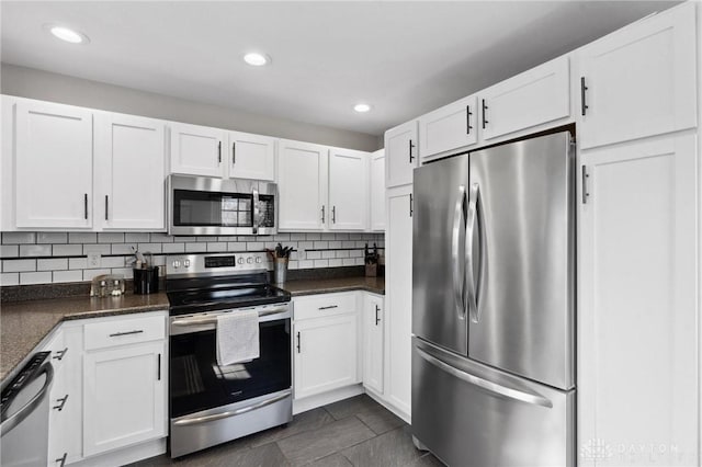 kitchen featuring recessed lighting, backsplash, appliances with stainless steel finishes, and white cabinets