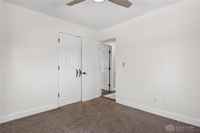 unfurnished bedroom with a closet, baseboards, a ceiling fan, and carpet flooring