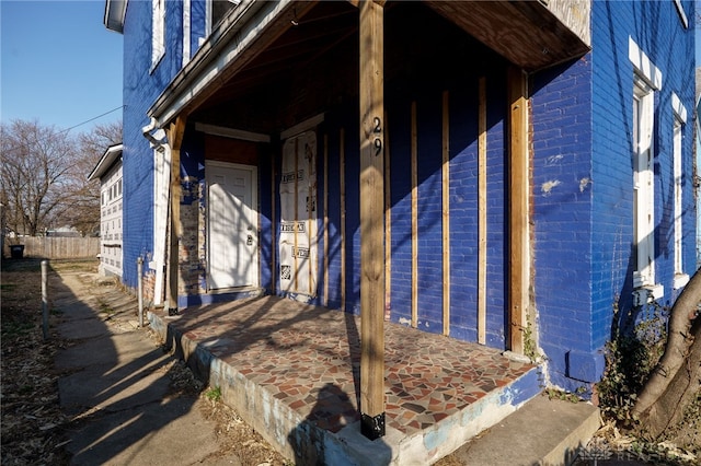 doorway to property featuring brick siding