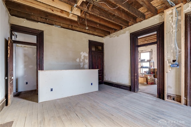 unfurnished room featuring visible vents and wood-type flooring