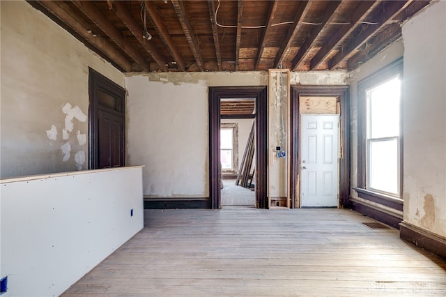 empty room with visible vents and wood-type flooring