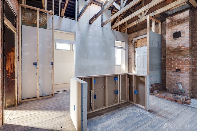 basement with plenty of natural light and hardwood / wood-style flooring