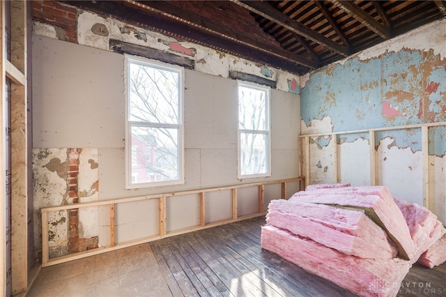 bedroom featuring wallpapered walls and hardwood / wood-style floors