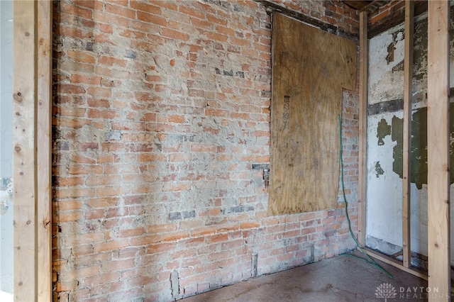 interior space featuring brick wall