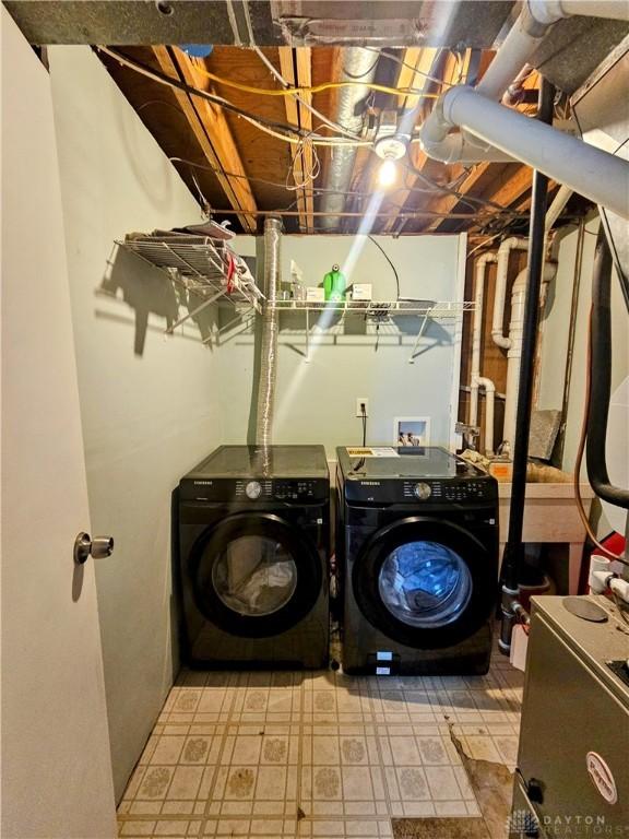 washroom with washing machine and dryer and laundry area