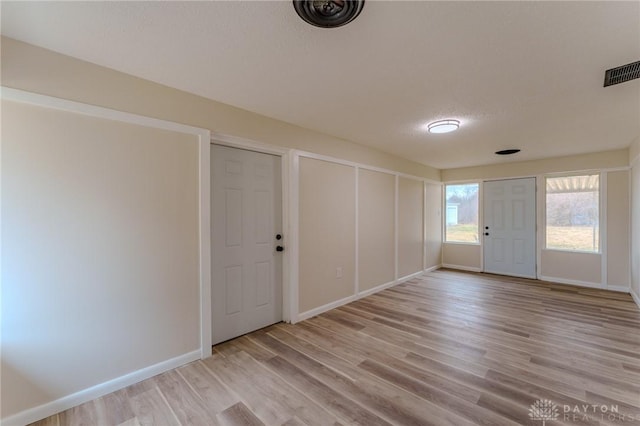 entryway featuring visible vents, baseboards, and light wood-style floors