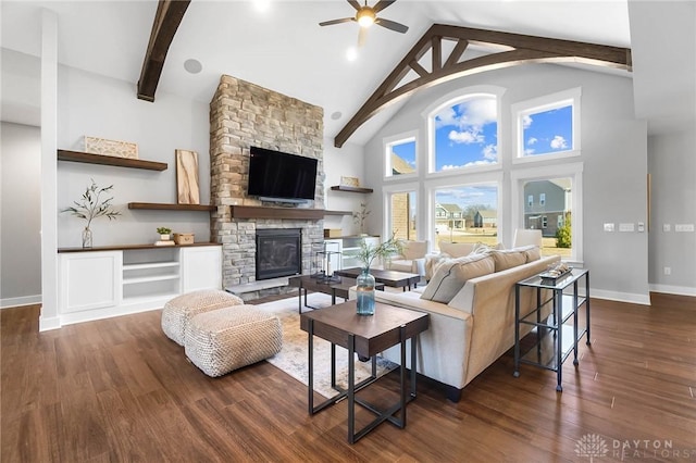 living room featuring dark wood-style floors, a ceiling fan, high vaulted ceiling, a fireplace, and beamed ceiling