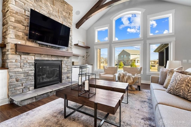 living area with baseboards, beam ceiling, a fireplace, wood finished floors, and high vaulted ceiling