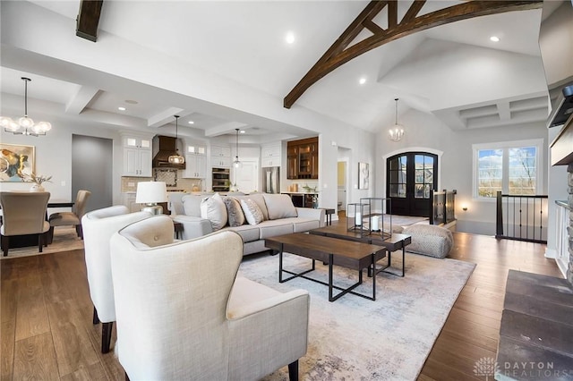 living room featuring high vaulted ceiling, dark wood finished floors, recessed lighting, beamed ceiling, and a chandelier