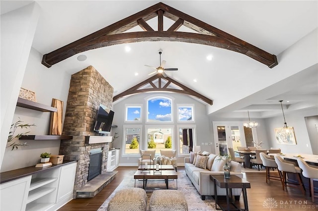 living room featuring beam ceiling, ceiling fan with notable chandelier, a fireplace, dark wood-style floors, and high vaulted ceiling