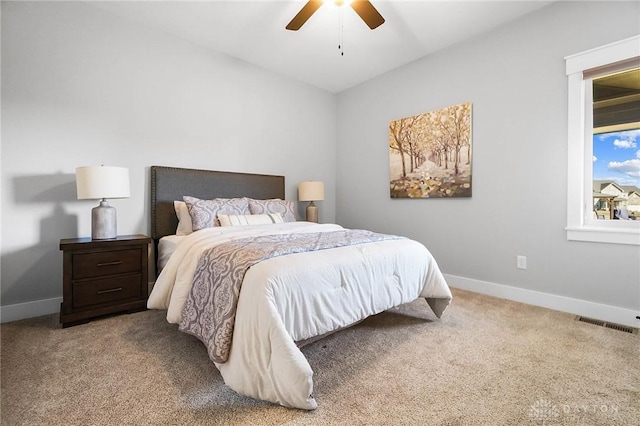 bedroom with visible vents, baseboards, carpet floors, lofted ceiling, and ceiling fan