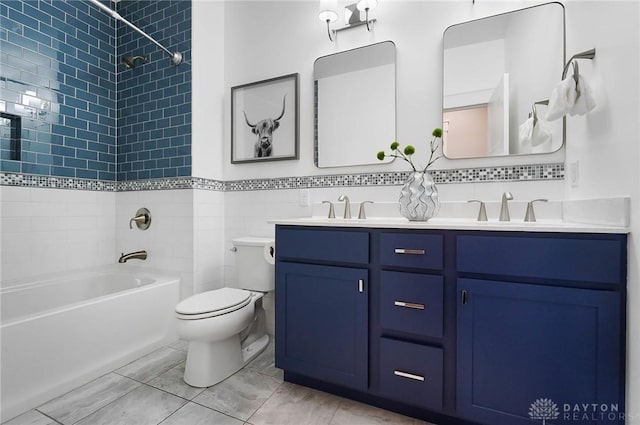 bathroom featuring double vanity, toilet, washtub / shower combination, and a sink