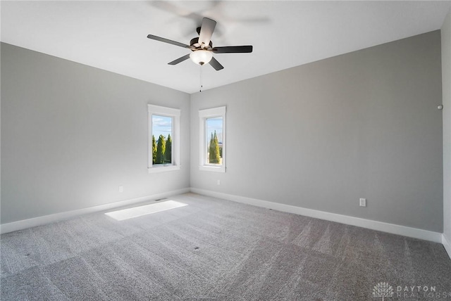 empty room with baseboards, carpet, and a ceiling fan