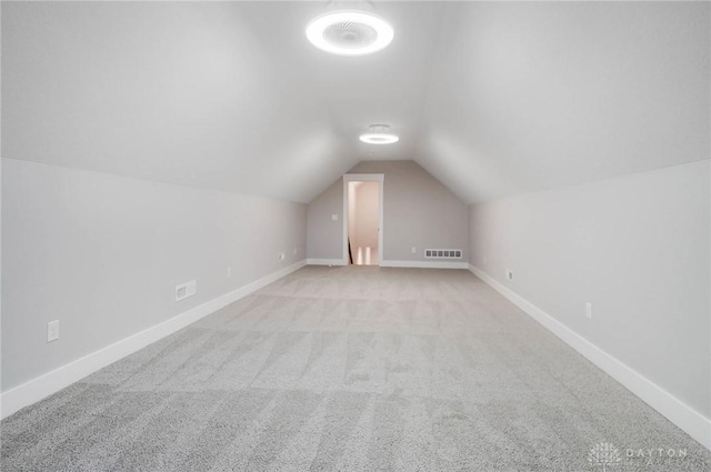 bonus room featuring visible vents, baseboards, carpet, and lofted ceiling