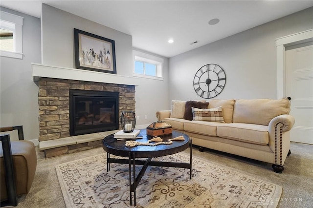 living area featuring carpet flooring, recessed lighting, a fireplace, and visible vents