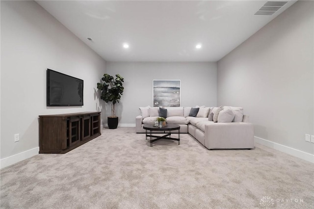 living area with visible vents, baseboards, and carpet floors