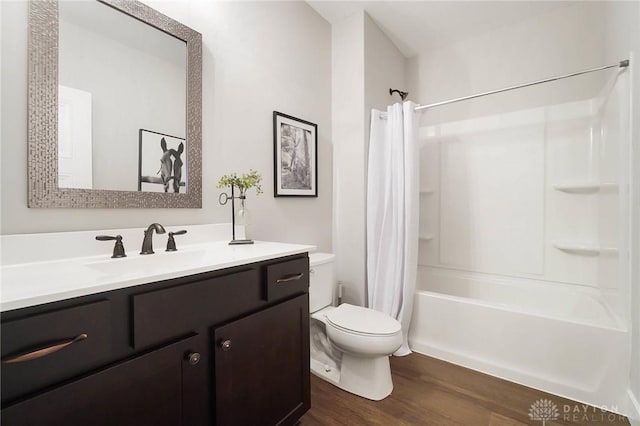 full bathroom with shower / tub combo, toilet, wood finished floors, and vanity