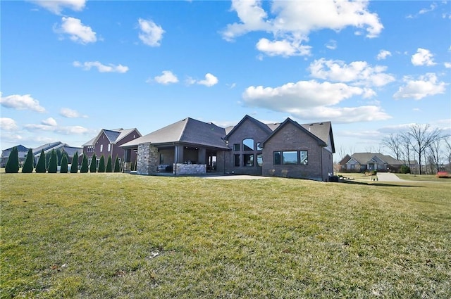 view of front of house with stone siding and a front lawn