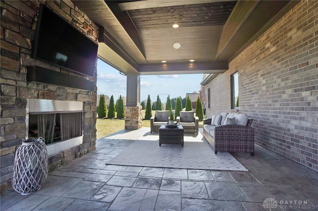 view of patio / terrace with an outdoor living space with a fireplace