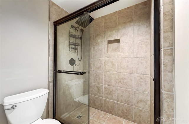 full bathroom with a stall shower and toilet