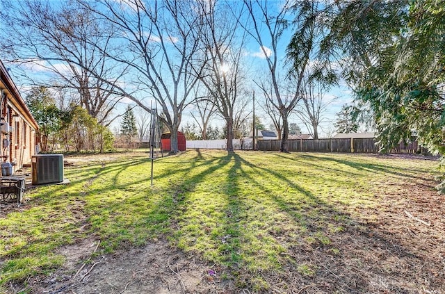 view of yard featuring central air condition unit and fence