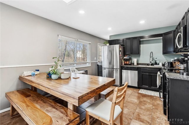 kitchen featuring recessed lighting, stainless steel appliances, and dark cabinetry