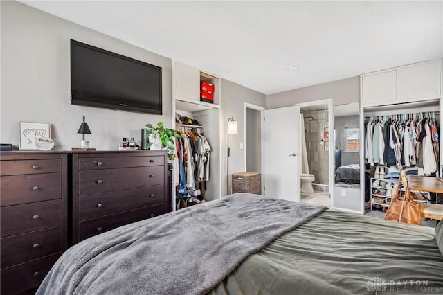 bedroom featuring a closet, a walk in closet, and ensuite bathroom