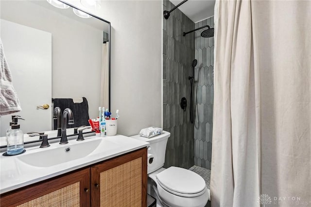 full bath with vanity, toilet, and a shower stall