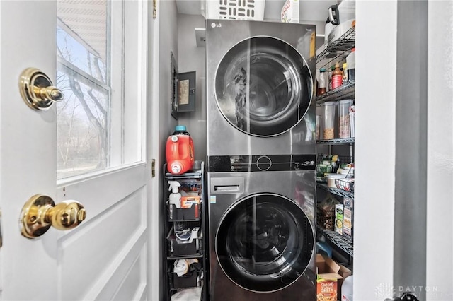 laundry area with laundry area and stacked washer / drying machine