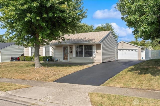 ranch-style home with a detached garage, an outdoor structure, and a front yard