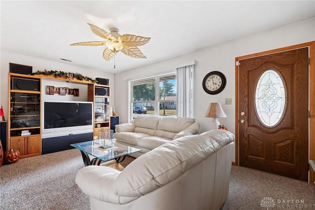 living area featuring carpet and ceiling fan