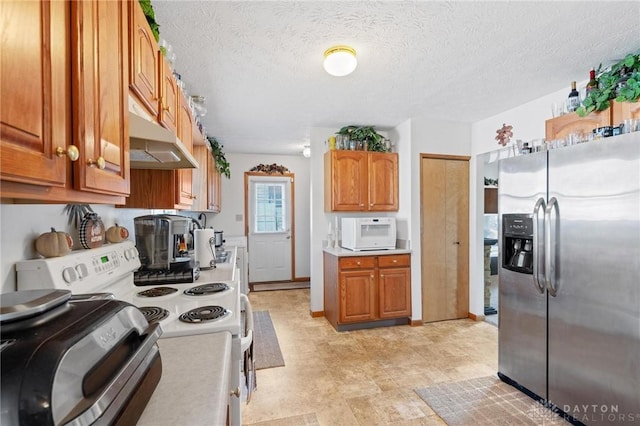 kitchen with white appliances, a textured ceiling, brown cabinets, and light countertops