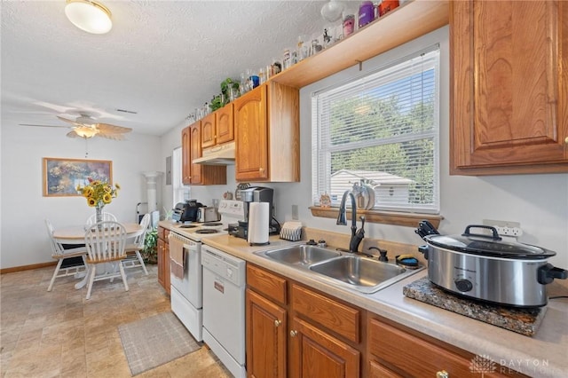 kitchen featuring white appliances, ceiling fan, a sink, light countertops, and under cabinet range hood