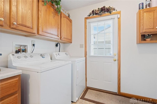 laundry area with cabinet space and independent washer and dryer