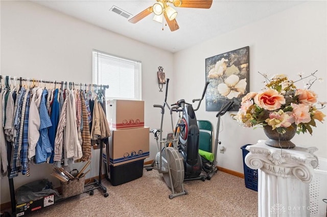 exercise area with visible vents, baseboards, ceiling fan, and carpet flooring