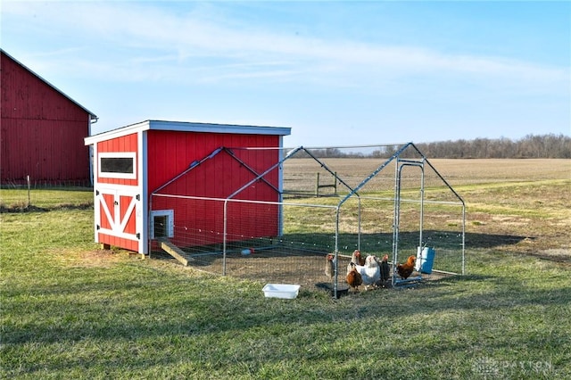 view of outdoor structure with a rural view and an outdoor structure