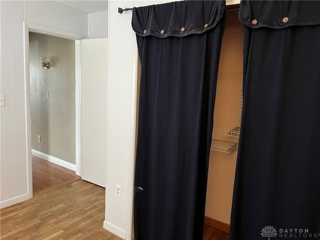 interior space featuring baseboards and wood finished floors