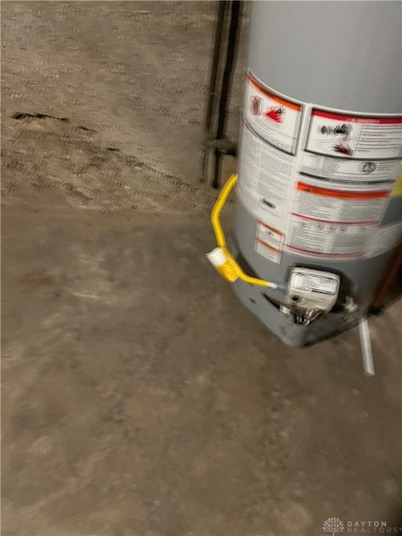 room details featuring water heater and concrete flooring