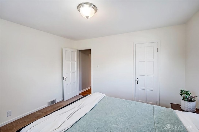 bedroom with visible vents, baseboards, and carpet flooring