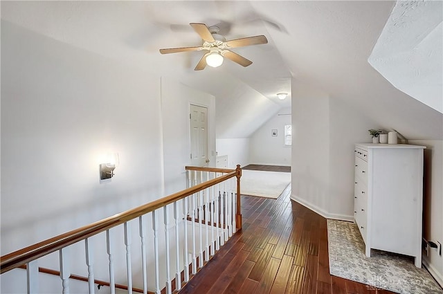 additional living space with ceiling fan, baseboards, dark wood-style floors, and vaulted ceiling