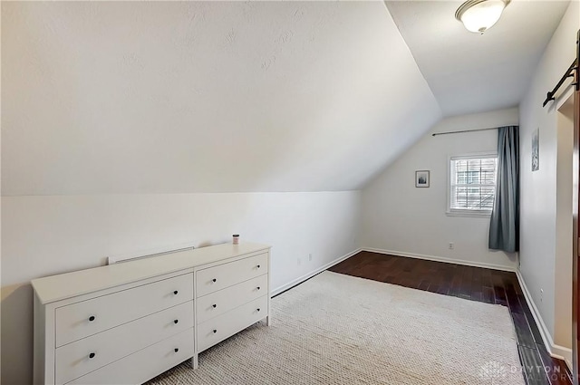 bonus room featuring baseboards, lofted ceiling, and wood finished floors