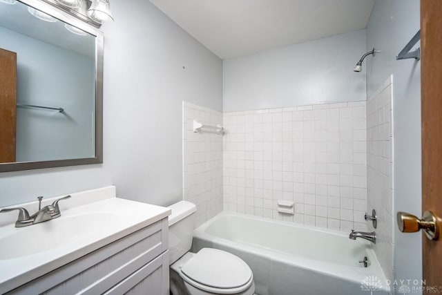 bathroom featuring toilet, vanity, and shower / tub combination